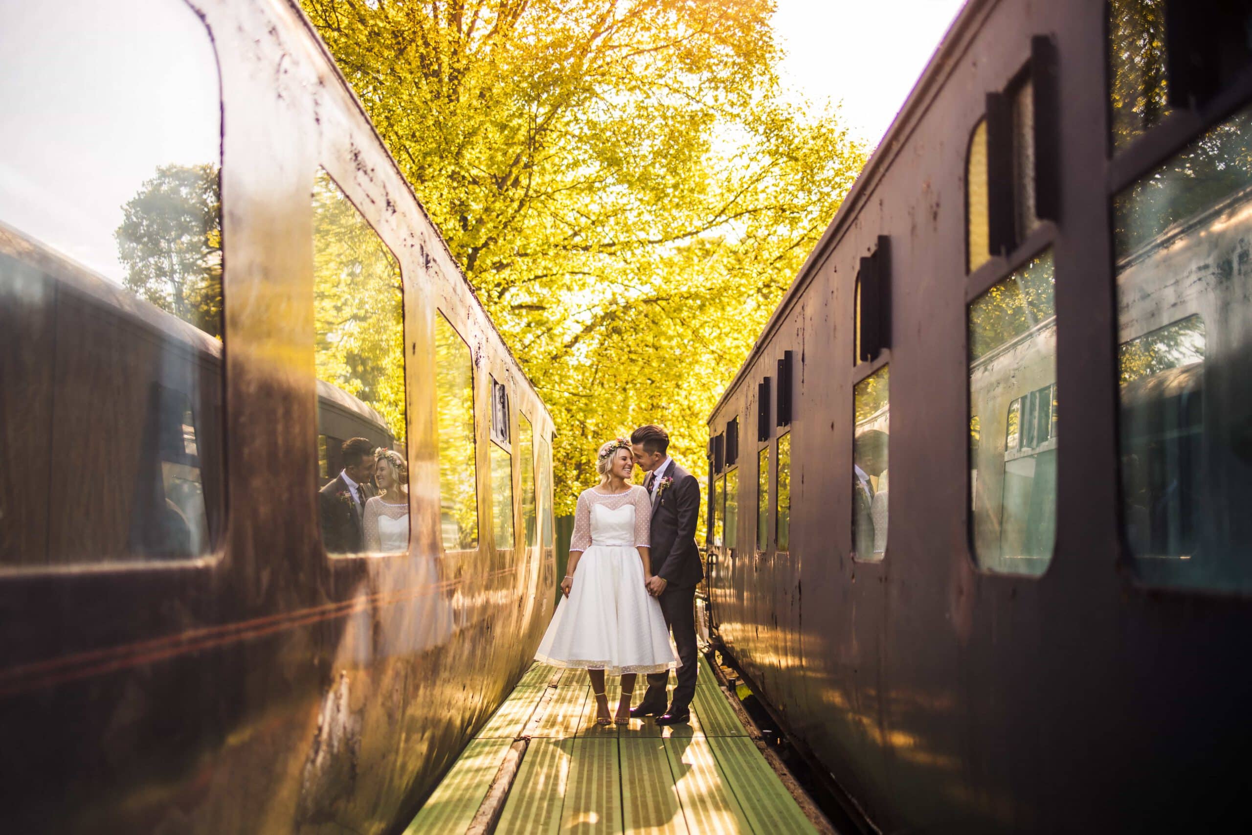 bride and groom, old train station, sunset