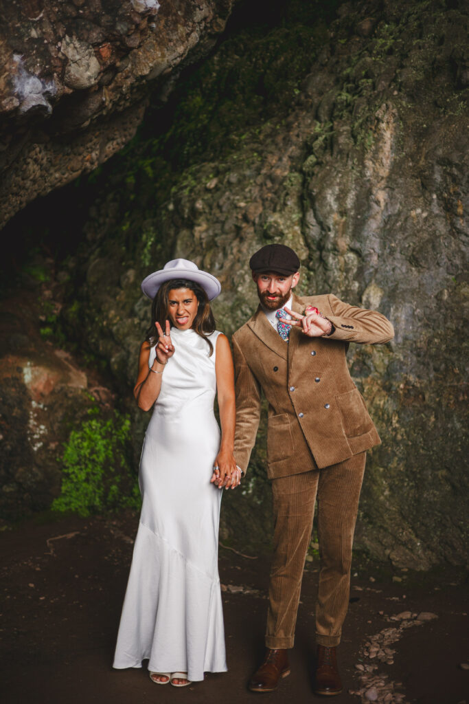 A bride and groom pose in the Cushendun Caves