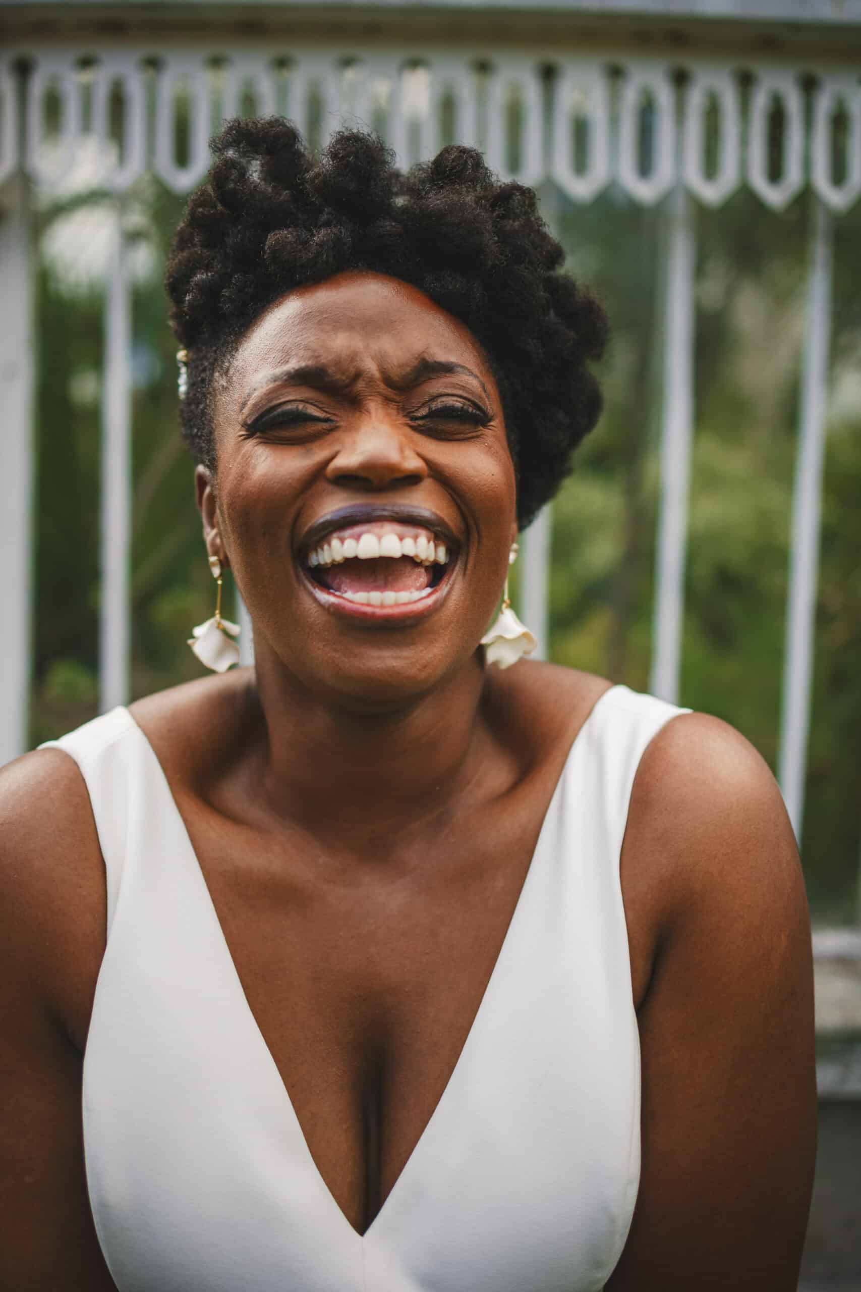 A black woman laughing at Botanic Gardens in Belfast