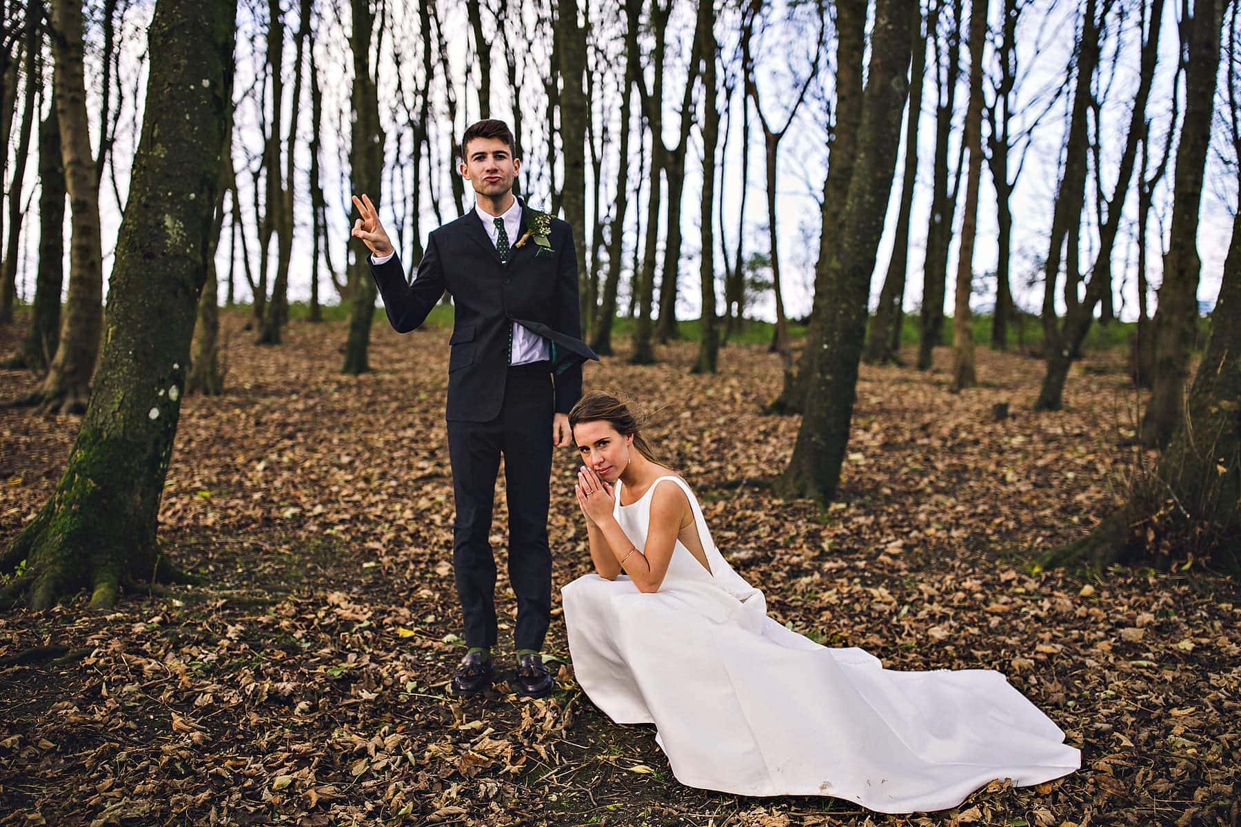 A bride and groom posing in the woods in Brighton.